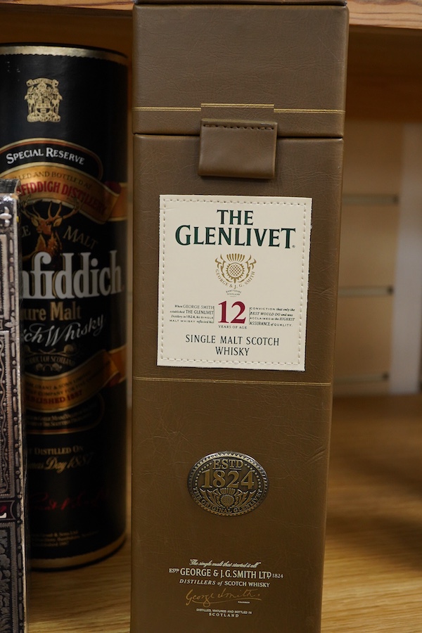 Four bottles of Whisky to include The Glenlivet 12 years aged single malt and two bottles of Glenfiddich, together with a bottle of brandy